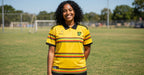 Jamaica yellow jersey worn by a woman on a soccer field